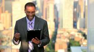 stock-footage-african-american-male-business-manager-on-a-tablet-overlooking-manhattan